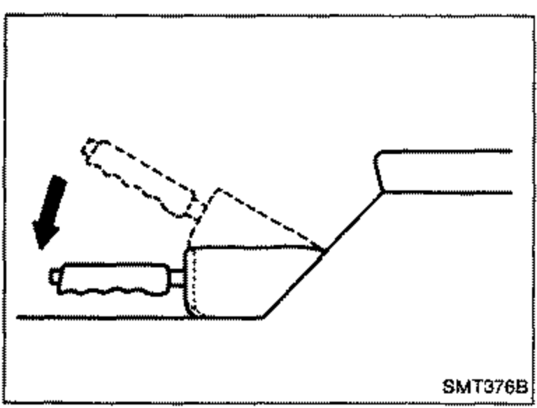 Close-up of a hand releasing the parking brake lever, with a downward arrow indicating the lever being lowered fully. Illustrates step 2.