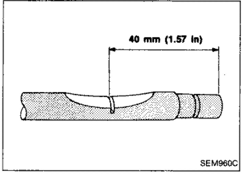 Illustration of an exhaust valve stem being marked with a serration 40 mm (1.57 in) from the end of the stem. A dimension arrow indicates the 40 mm (1.57 in) distance along the stem.