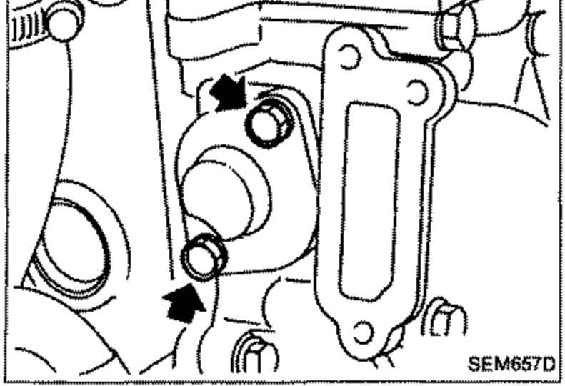 Photo of the lower chain tensioner installation area with arrows indicating mounting points.