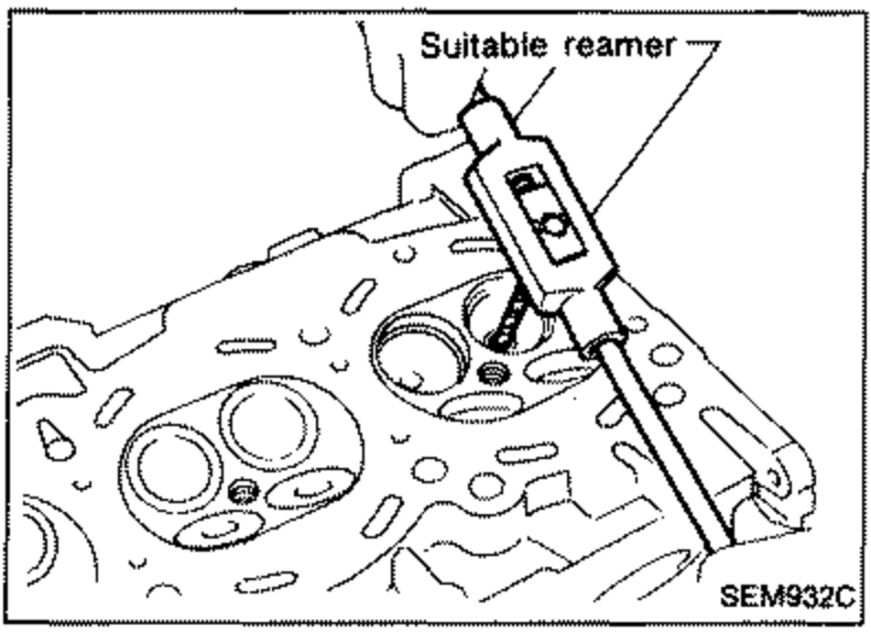 Illustration of reaming the cylinder head valve guide hole using a suitable reamer. Label 'Suitable reamer' points to the reaming tool.