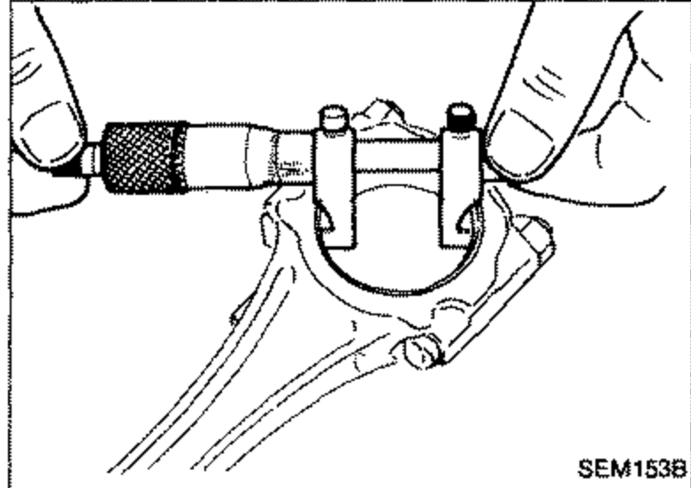 A bore gauge / inside micrometer measuring the inner diameter 'C' of a connecting rod big-end bearing with the cap installed.