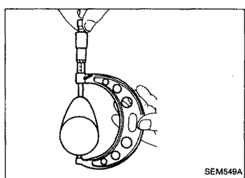 Illustration showing a micrometer or height gauge measuring camshaft cam height, with the gauge spindle resting on the cam lobe nose.