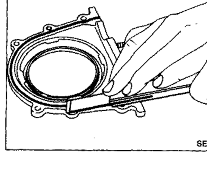 Rear of cylinder block showing the rear oil seal retainer area where liquid gasket traces must be removed before installing the rear oil seal retainer.