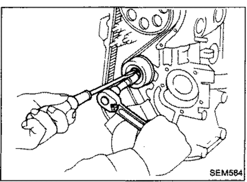 Hands using a wrench on the tensioner lock nut while preventing the tensioner from turning, on the front of the engine.