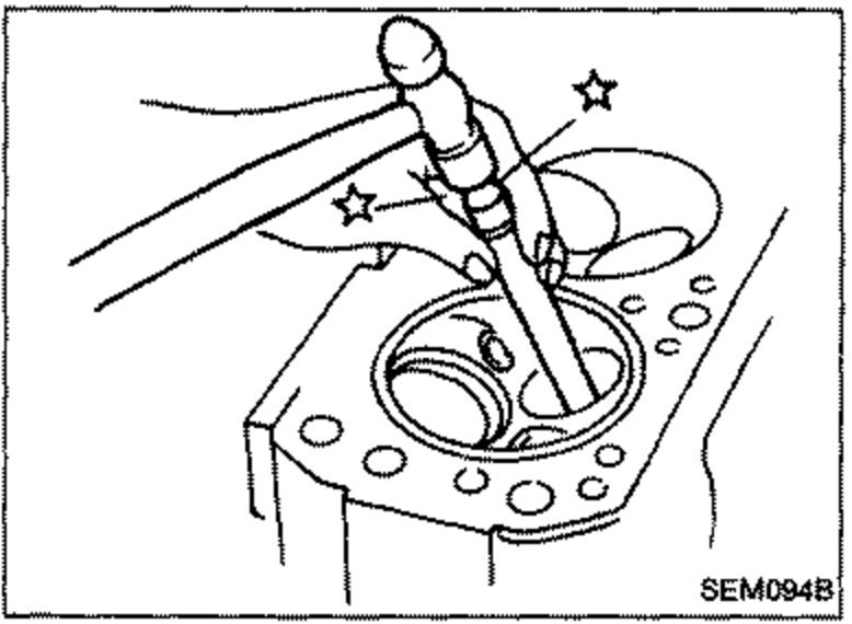 Driving out the valve guide with a hammer and suitable tool/drift through the cylinder head.