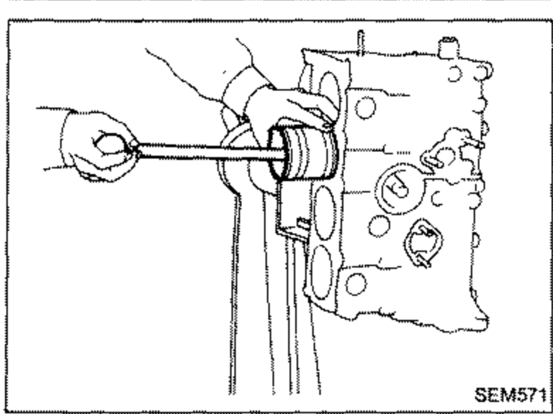 Installing piston with connecting rod into the cylinder bore using a piston ring compressor tool.