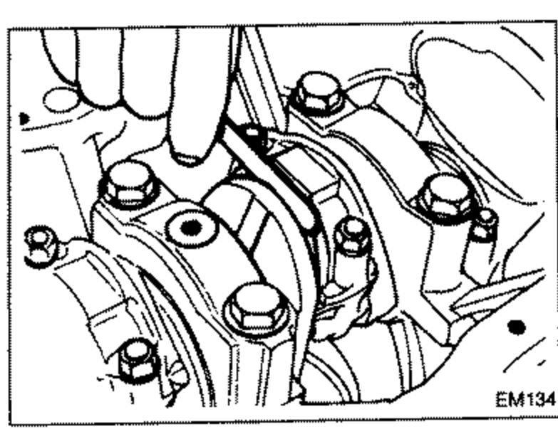 Measuring connecting rod side clearance with a feeler gauge between the connecting rod big end and the crankshaft, with the crankshaft and connecting rod caps installed on the block.