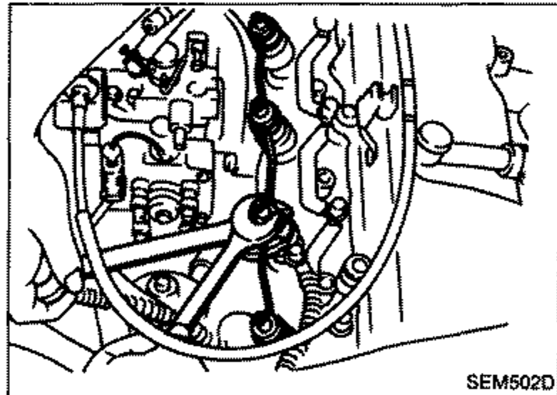Photo of the engine showing the spill tube being installed while holding the nozzle holder.