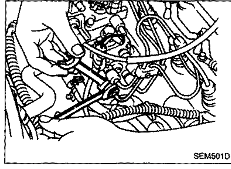 Photo of the engine showing injection tubes being installed using two wrenches.