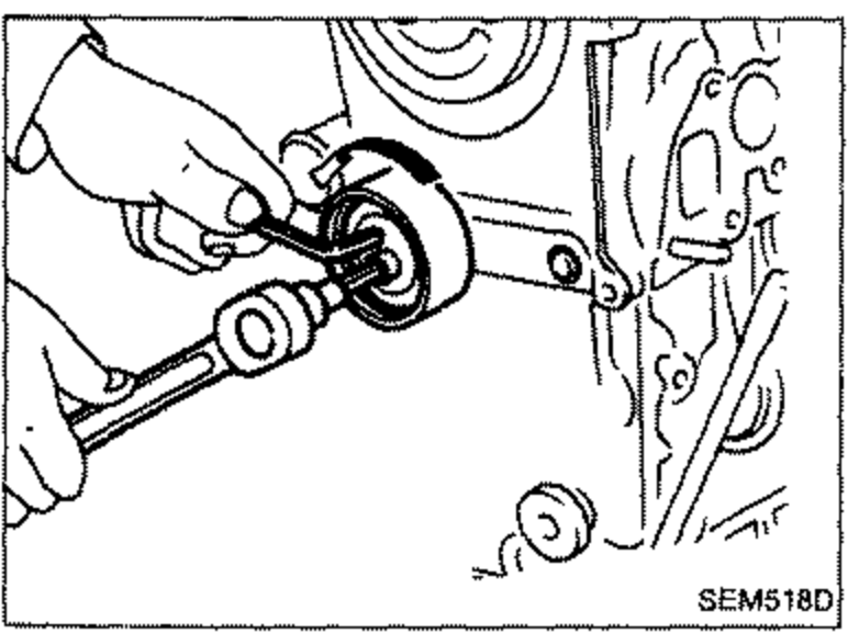 Tensioner and return spring installation at the lower front of the engine.