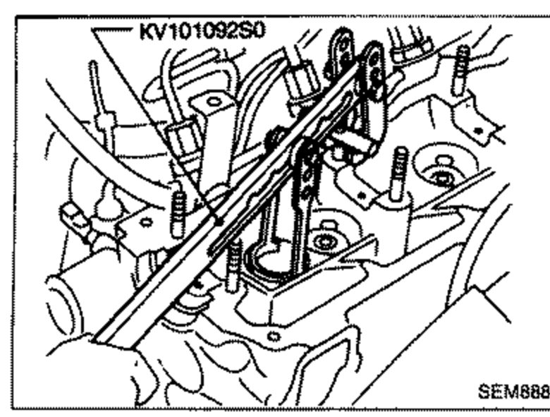 Cylinder head with tool KV10109250 installed to remove camshaft brackets / camshaft, related to removing camshaft sprockets and back covers.