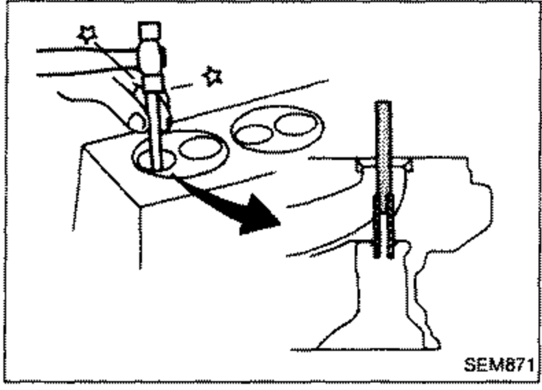 Press or hammer with a suitable drift driving out a valve guide from the cylinder head.