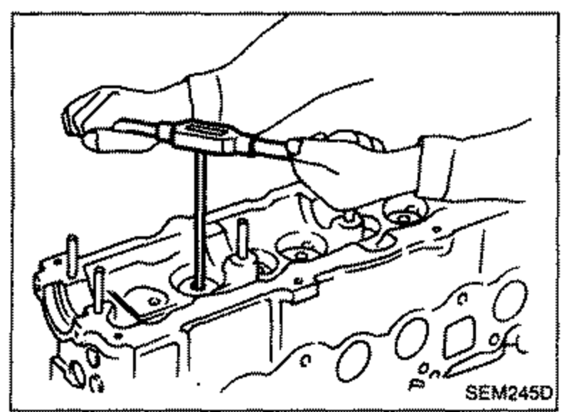 Reamer being used to ream the cylinder head valve guide bore on the cylinder head.