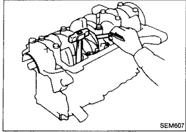 Crankshaft free end play measurement using a dial gauge mounted against the crankshaft to measure axial movement at the center bearing.