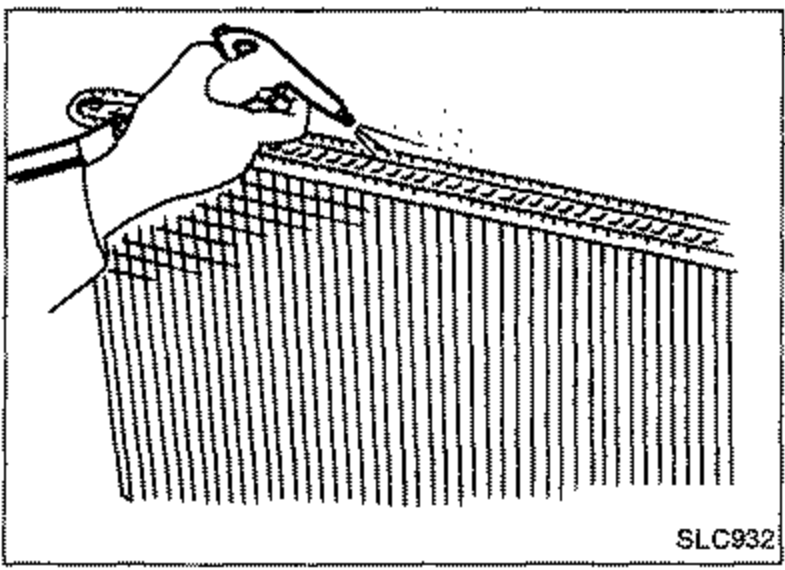 Illustration of a hand cleaning the contact portion of the radiator tank.