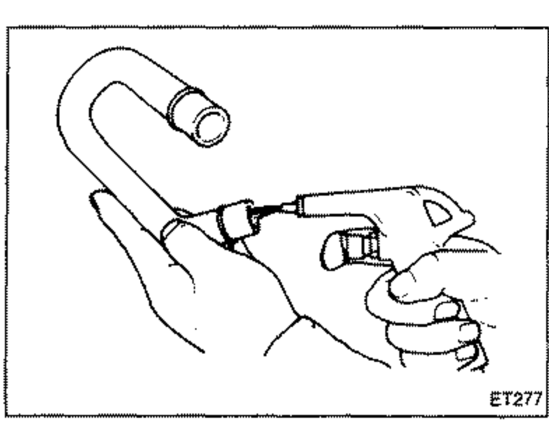 Line illustration of a hand holding a ventilation hose and using a compressed-air blow gun to clean the inside of the hose. The curved hose loops at the top with a fitting at the end.