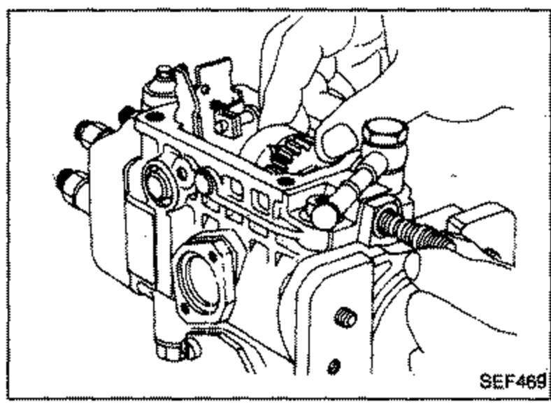 Hand removing the governor sleeve, washer and flyweight along with flyweight holder from the pump.