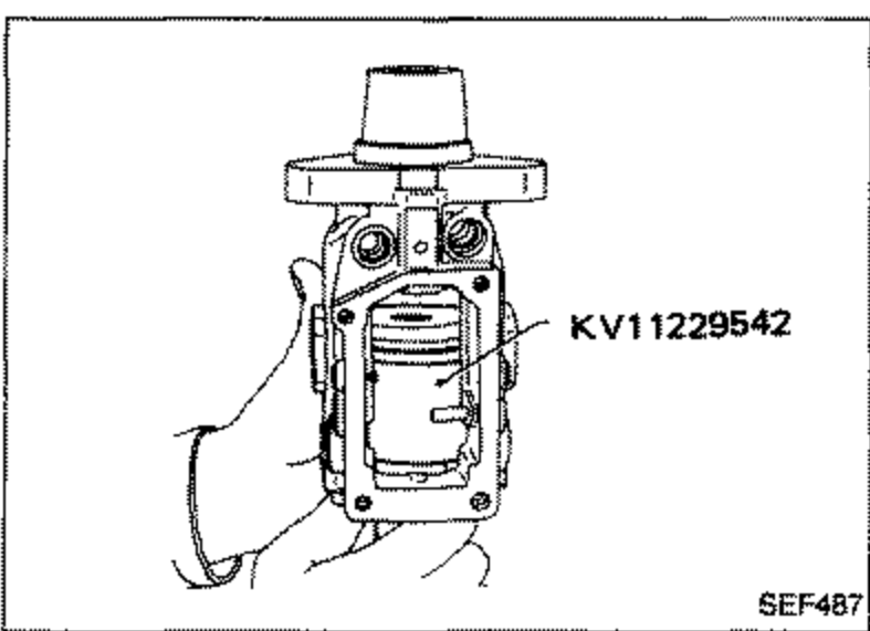 Cover and feed pump assembly being removed as a unit using special tool KV11229542 (feed pump holder) inserted into the pump housing.