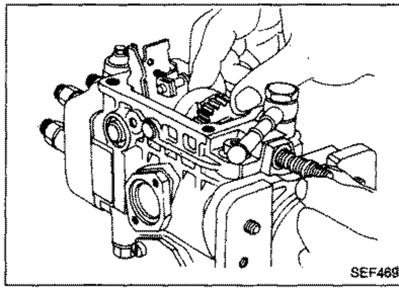 Injection pump assembly viewed from the side/front, illustrating removal of lock nut, governor shaft and flyweight assembly.