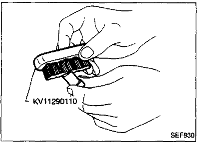 Illustration of a hand holding the nozzle body and using special tool KV11290110 to remove carbon from the exterior of the nozzle body.
