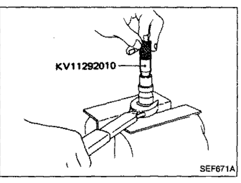 Illustration of a hand using special tool KV11292010 during assembly of the nozzle body, with the tool engaging the nozzle assembly held in a fixture.