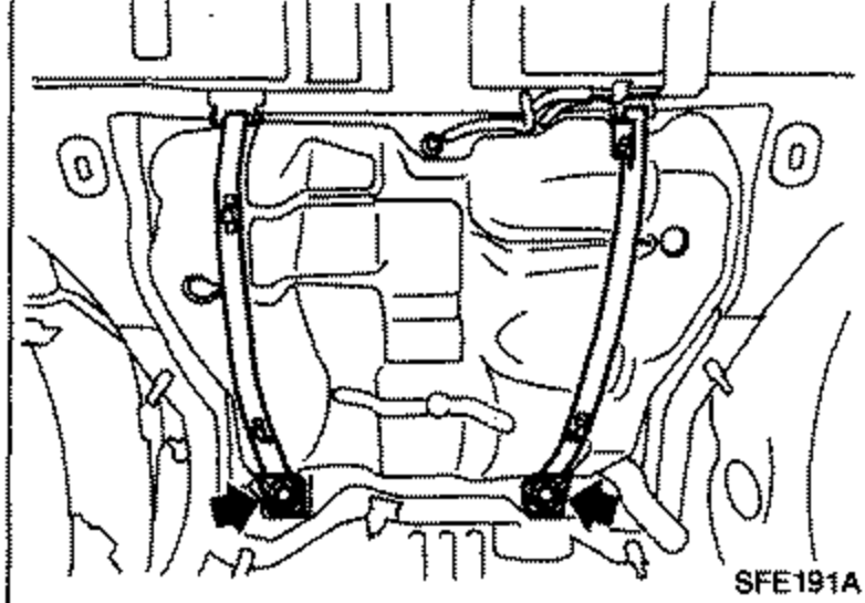 Underbody view showing the fuel tank mounting band bolts being removed while supporting the fuel tank.