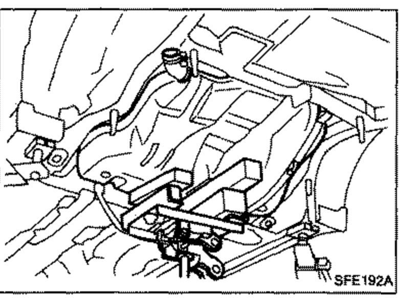 Underbody view showing the fuel tank being removed from the vehicle.